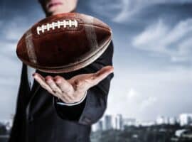 NFL agent holding football