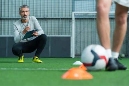 soccer coach supervising the training.