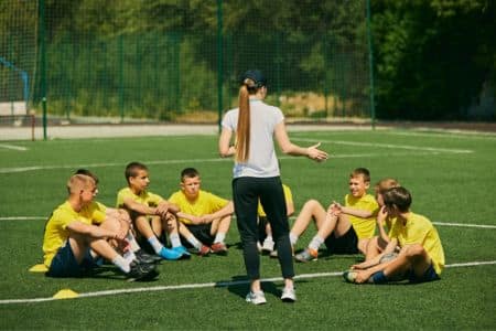 youth soccer coach giving instructions to the players.