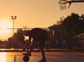 Basketball player on a California court at sunset