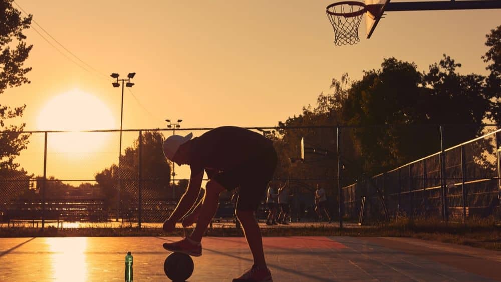 Basketball player on a California court at sunset