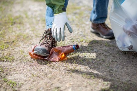 Grounds crew member picking up trash after getting a Daytona Speedway job