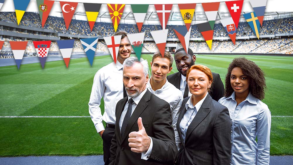 6 people in international sports management posing on soccer field