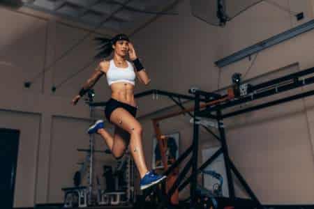 Person with motion capture sensors running in a biomechanical lab