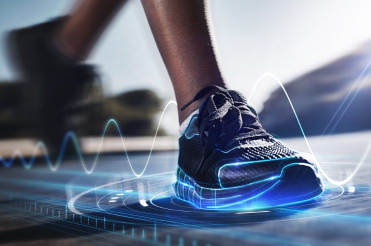 A running person's shoe surrounded by a blue hologram.