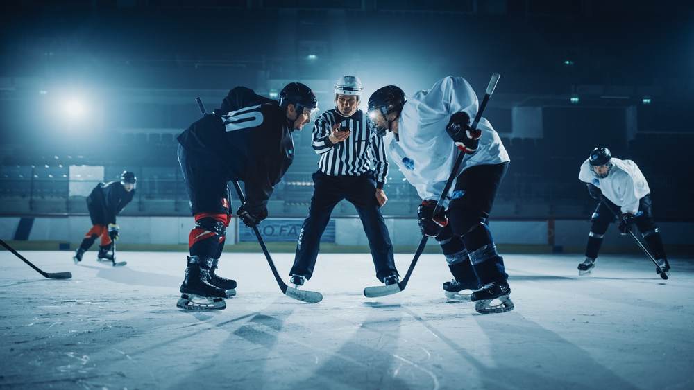 A hockey referee getting ready to officially start a match