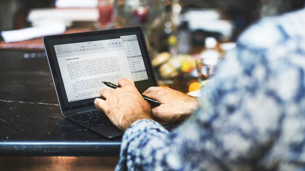 Sports columnist working on a laptop