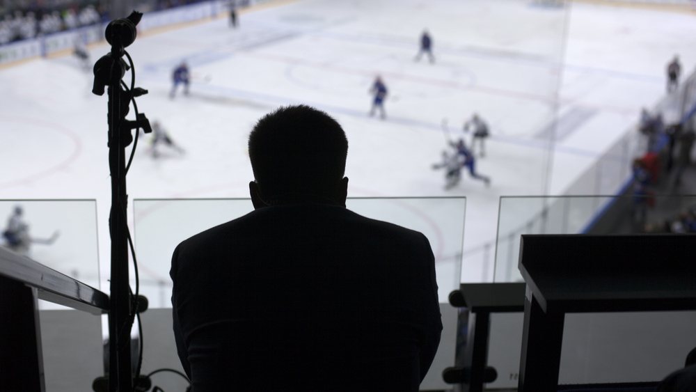 Sports scout watching a hockey game