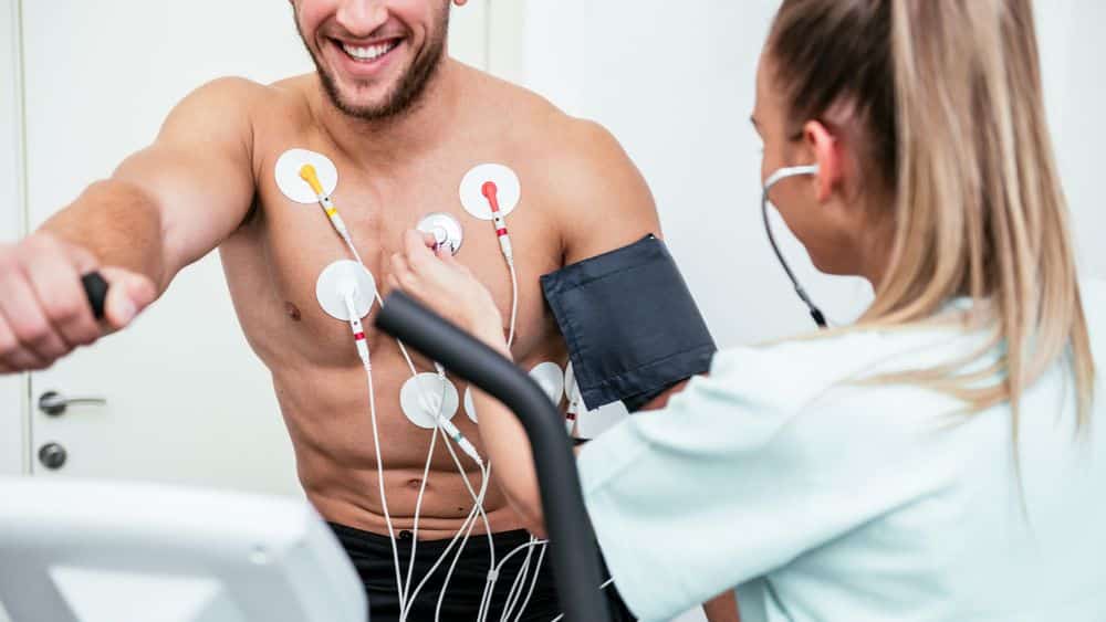 An NFL nurse performing a cardiology test on an athlete