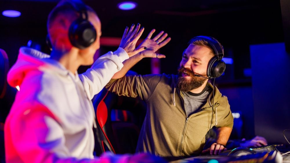 Two gamers at an event giving each other a high five