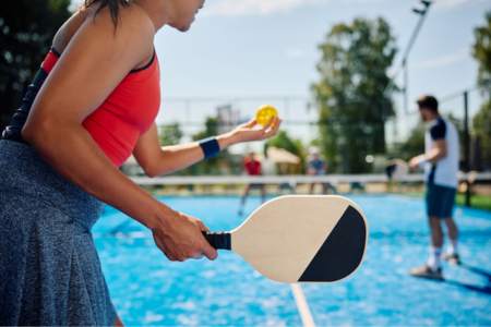 Person practicing pickleball on a pickleball court