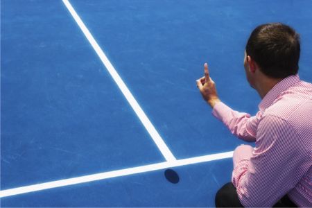 Tennis umpire giving instructions during a tennis match