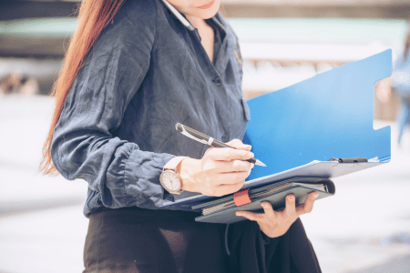 Event planner on the phone and writing in a notebook