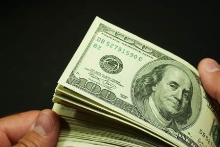 Hockey referee looking through a stack of money