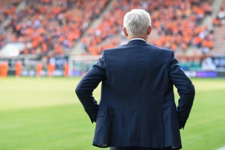 A soccer scout observing a soccer game