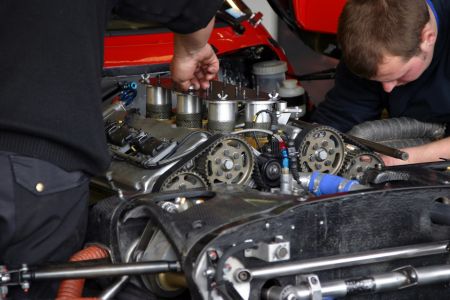 Race car mechanics fixing a car