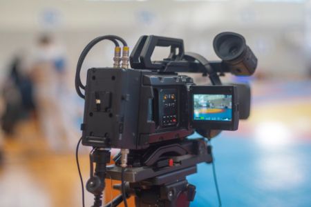 A video camera being used to record a WNBA game