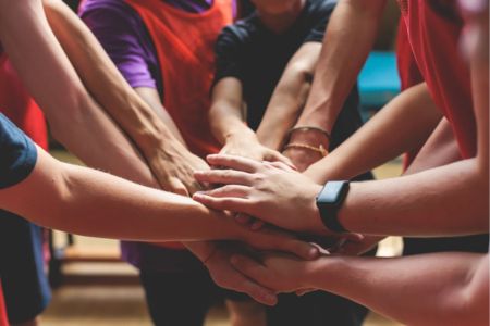 Team of people performing a hand stack