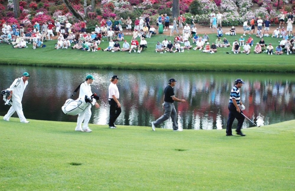 People on a field performing gold jobs