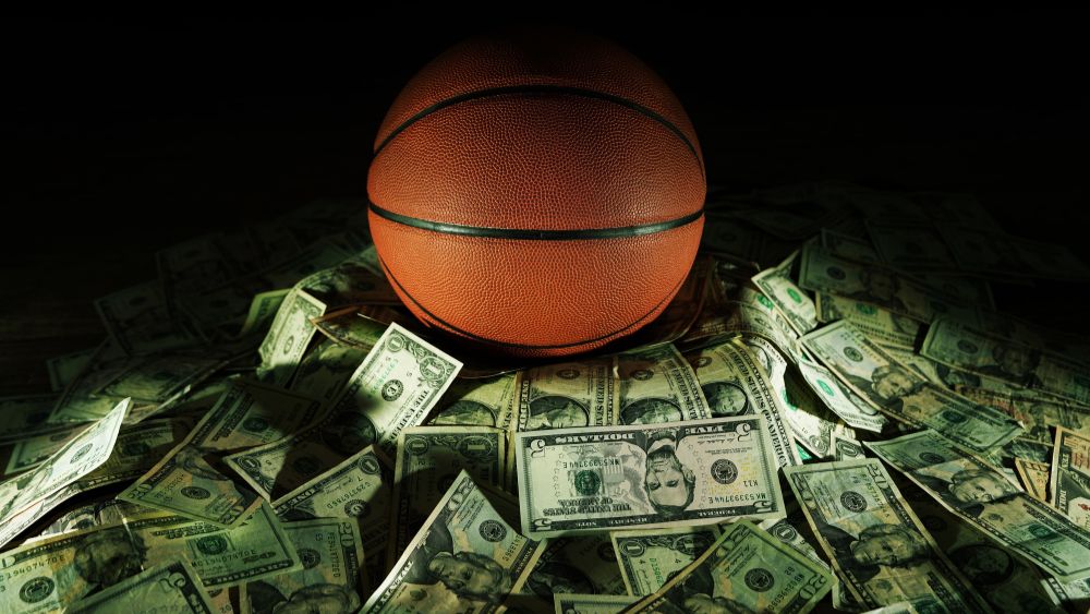 Basketball sitting atop a pile of cash