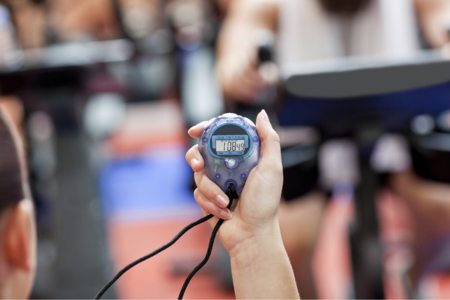 An NFL athletic trainer using a stopwatch