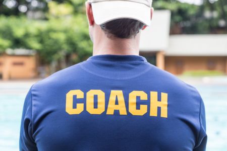 Person with a shirt that says "Coach" on the back