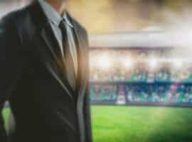 A sports event coordinator standing in a stadium.