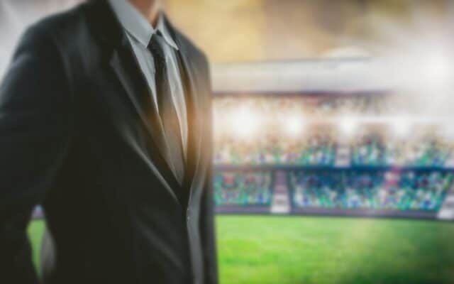 A sports event coordinator standing in a stadium.