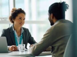 Woman interviewing a man for sports marketing job.