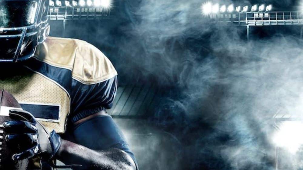 NFL careers off the field being depicted by football player holding football on field