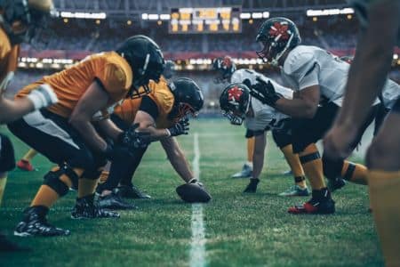 football players on the field before a play.