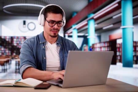 Man studying in a library.