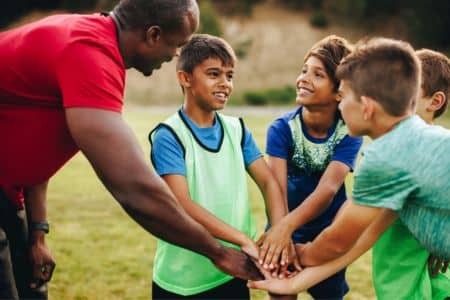 PE teacher on the field with students.