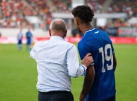 coach giving instructions to a player.