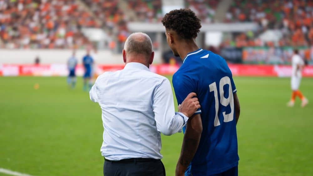 coach giving instructions to a player.
