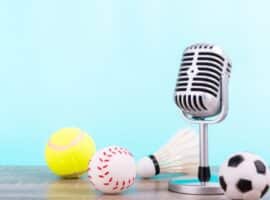 radio microphone surrounded by sports balls.