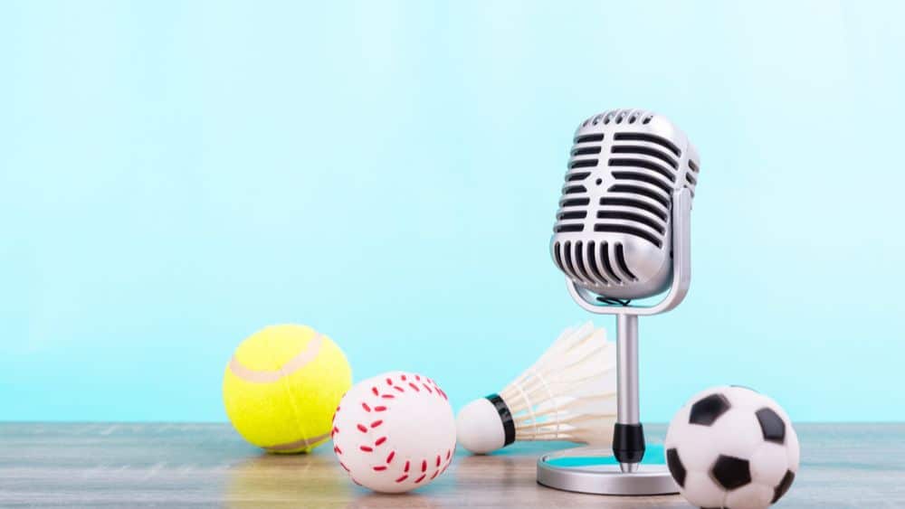 radio microphone surrounded by sports balls.