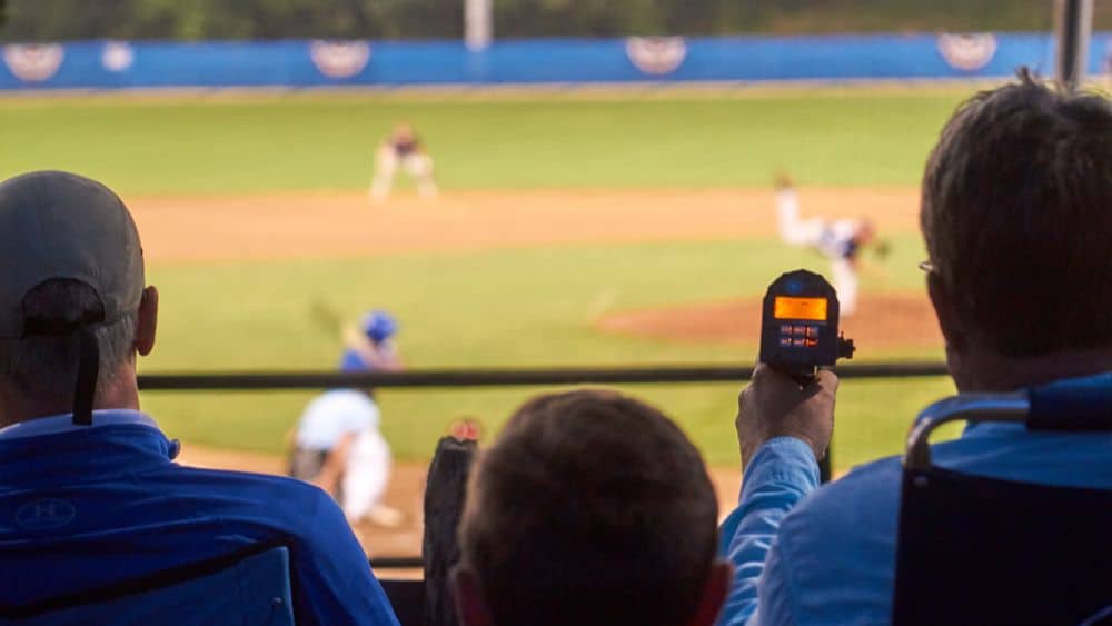 baseball scout using radar during a baseball game