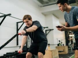 Personal trainer with client working out.