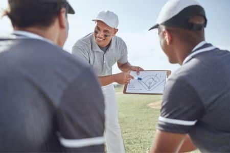 baseball coach giving instructions to players.
