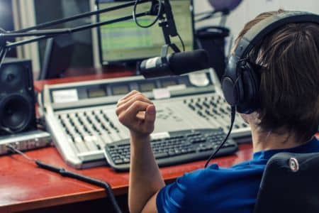 radio host in front of his equipment.
