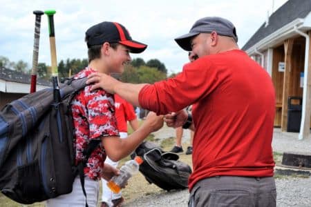 youth coach encouraging young player.