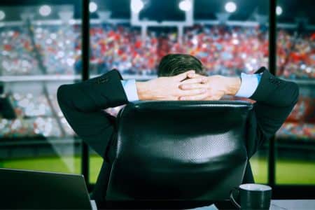 rear view of a businessman watching a game.