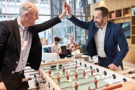 businessmen playing foosball.