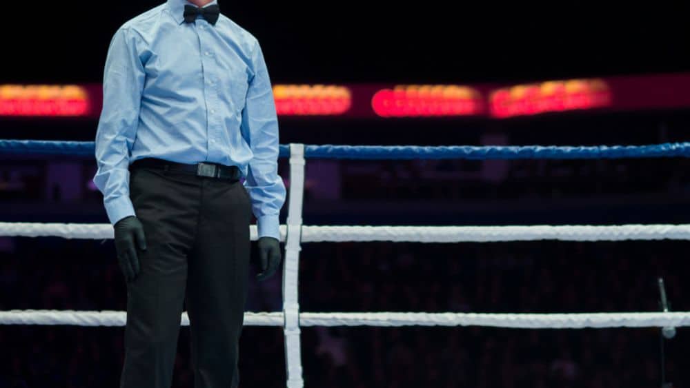 boxing referee standing in the ring.
