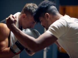 boxer and coach pressing foreheads during training