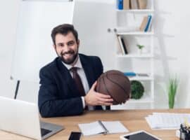 young businessman with a basketball in the workplace