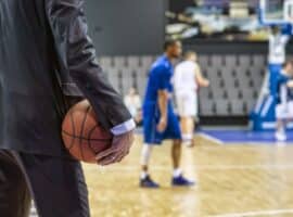 basketball executive observing game from sideline