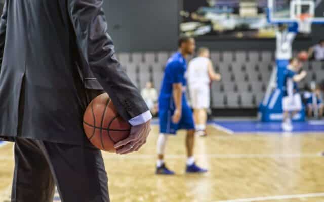 basketball executive observing game from sideline
