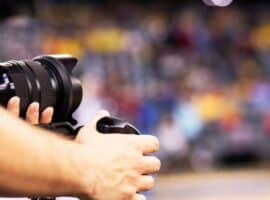 sports videographer filming live game action